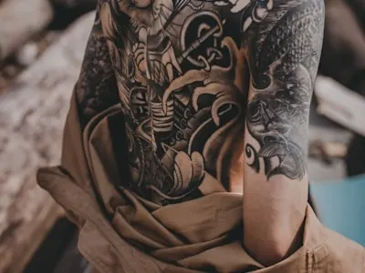 Tattoo artist working on a tattoo in a studio